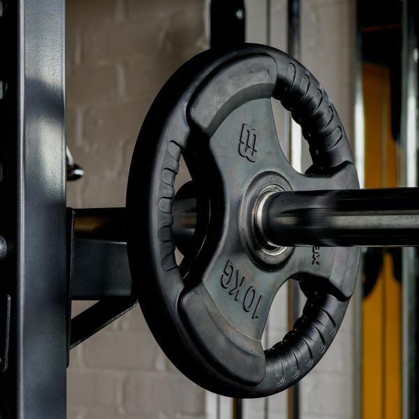 Detail of a barbell with heavy weights in the gym